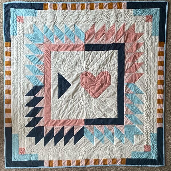 A gorgeous, handmade quilt by nerdfighter Kailey deWeever just for the P4A! It measures 72” x 72” inches and was adapted from a pattern called “Floyd” by Toad and Sew.

US only please