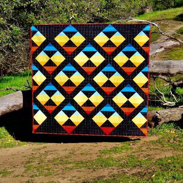A throw sized quilt (60” x 63”) inspired by an orbital sunrise made by nerdfighter April Singleton. Based on a pattern called New Horizons by Suzy Williams. Comes with two pillow cases! US only please.