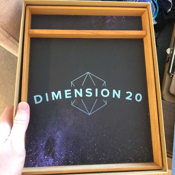 A gorgeous Wyrmwood crafted dice tray featuring the Dimension 20 branding and signed by the cast.